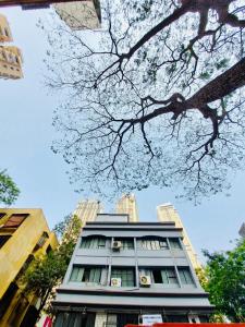 a tall building with a tree in front of it at Kalpataru Hometel in Mumbai +10 photos