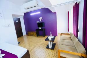 a living room with a couch and a table at Kalpataru Hometel in Mumbai