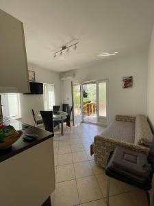 a kitchen and a living room with a bed and a table at Apartment Sajković in Ugljan