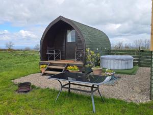 a green dome tent with a table in front of it at Cherry Trees Farm Campsite in Welton