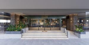 a lobby of a building with the front door open at Hotel Royal Queens in Singapore