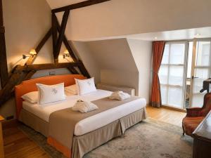 a bedroom with a large bed with white pillows at Hotel Le Dixseptième in Brussels +77 photos