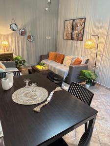 a living room with a table and a couch at Aliki's house in Líthion