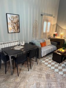 a living room with a table and a couch at Aliki's house in Líthion
