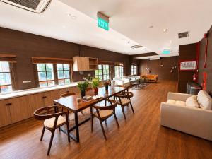 a conference room with a table and chairs and a couch at Bugis Social-Newly Renovated in Singapore