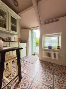 a kitchen with a table and a window at The Old Feed Store in Okehampton