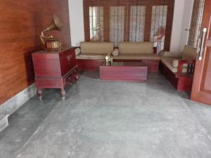 a living room with a couch and a table at Maple Suite in Kadawata