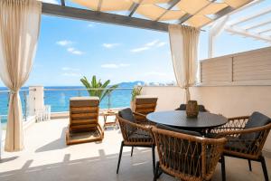 a dining room with a view of the ocean at 8MOONS Boutique Apartments in Kokkari +104 photos