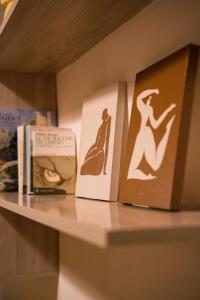 two books sitting on a shelf next to a book at L'abbraccio in Dolceacqua