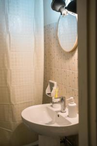 a bathroom with a sink and a mirror at L'abbraccio in Dolceacqua