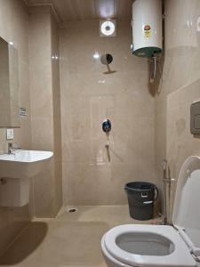 a bathroom with a toilet and a sink at Arunachal residency in Dibrugarh