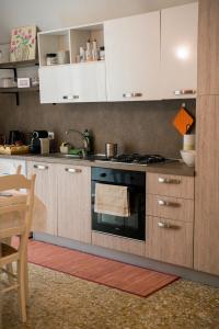 a kitchen with white cabinets and an oven at L'abbraccio in Dolceacqua