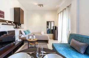 a living room with a bed and a couch at Elysian Hightower in Thessaloniki