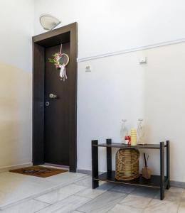 a hallway with a door and a table with a basket at Elysian Hightower in Thessaloniki