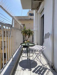 a table and chairs on the balcony of a building at Elysian Hightower in Thessaloniki