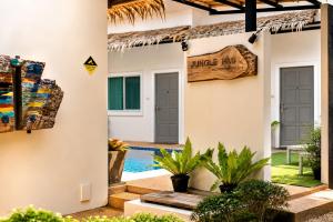 a villa with a swimming pool and a house at jungle pad accomodation in Rawai Beach