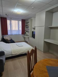 a bedroom with a bed and a table in it at Brussels square in Brussels