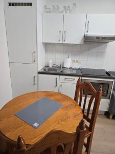 a kitchen with a wooden table and a sink at Brussels square in Brussels