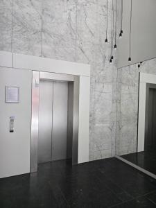 a room with a door and a marble wall at Brussels square in Brussels +3 photos