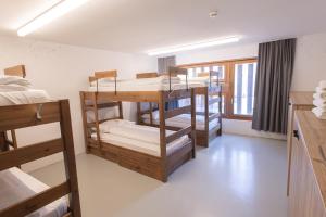 a room with three bunk beds in a room at Vercorin group lodge 18 people in Chalais