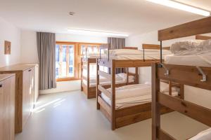 a room with several bunk beds in a dorm at Vercorin group lodge 18 people in Chalais