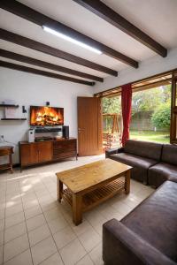 a living room with a couch and a fireplace at Prananto's Villa in Lembang +30 photos