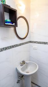 a bathroom with a sink and a mirror at La Milagrosa in Caracas +5 photos