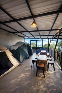 a room with two tents and tables and chairs at Prananto's Villa in Lembang