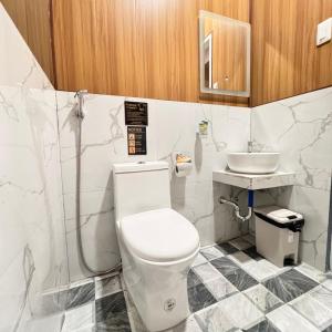 a bathroom with a toilet and a sink at La Palma Air'bnb Malaybalay in Casisang