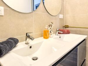 a bathroom with a white sink and a mirror at Chic Bastide in Carcassonne +34 photos