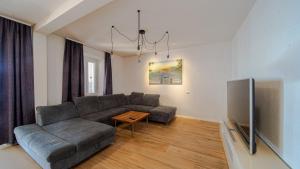 a living room with a couch and a table at Villa Estera by Villas Guide in Ston