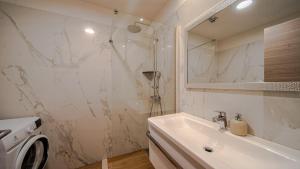 a white bathroom with a sink and a shower at Villa Estera by Villas Guide in Ston +34 photos