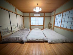 a large bed in a room with windows at とまり木 in Yoshino +23 photos