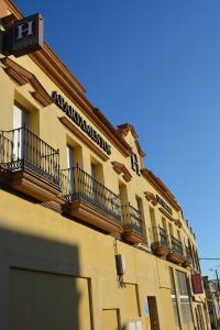 a building with balconies on the side of it at Apartamentos Turísticos La Terraza* in Las Cabezas de San Juan