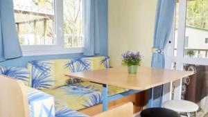a dining room with a table and a couch at ZEcamping 3 étoiles chiens acceptés piscine bar et restaurant in Mézel
