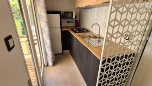 a small kitchen with a sink and a counter at ZEcamping 3 dog friendly piscine dans le parc régional du Verdon in Valensole