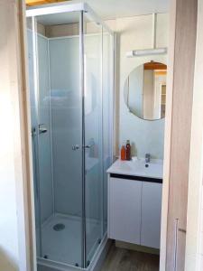 a bathroom with a glass shower and a sink at ZEcamping 3 étoiles à 1km de la plage piscine jacuzzi animaux acceptés in Viggianello +48 photos