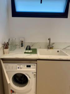 a kitchen with a washing machine and a sink at Studio Noélie in Antibes +5 photos