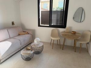 a living room with a couch and a table at Studio Noélie in Antibes