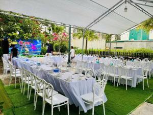 a row of white tables and chairs in a marquee at Ks Luxhotel flc sầm sơn in Sầm Sơn