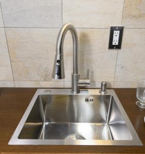 a stainless steel sink in a kitchen at NOW Onomichi in Onomichi +26 photos