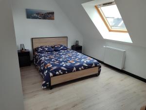 a bedroom with a bed in a white room at Chez Audrey et Christophe in Saint-Pol-de-Léon