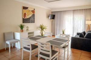 a kitchen and living room with a table and chairs at Giramar Apartamentos Turisticos in Lagos +7 photos