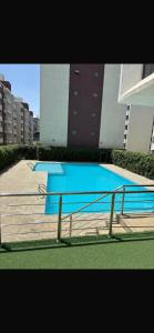 an empty swimming pool in front of a building at Naisolas place in Marimbeti