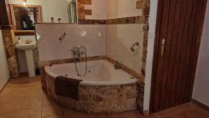 a bathroom with a bath tub with a sink at El callejón del Santo in Ubrique