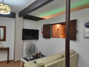 a living room with a couch and a rainbow on the wall at El callejón del Santo in Ubrique