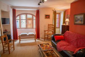 a living room with a couch and a table at Chez mamiethé in Ispagnac