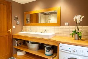 a bathroom with a white sink and a mirror at Chez mamiethé in Ispagnac +38 photos