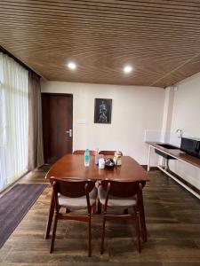 a dining room with a table and two chairs at Zimba Cottage Retreat 2 in Kalimpong