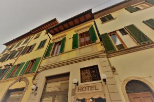 a building that has a sign on the side of it at Hotel Palazzuolo in Florence